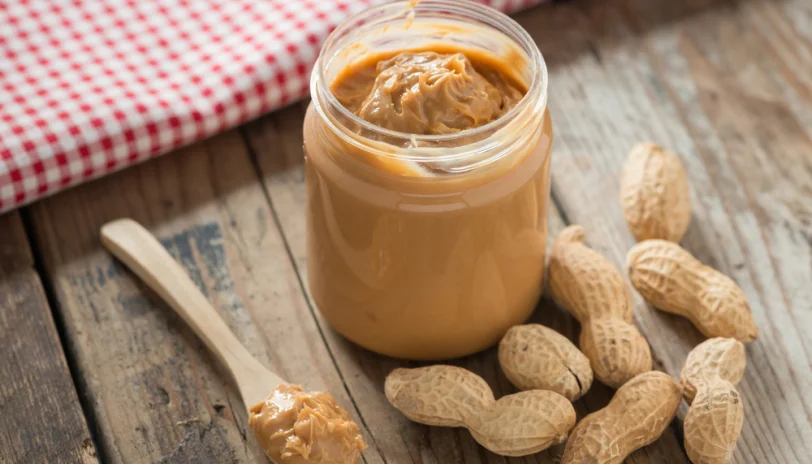All-natural peanut butter can be a healthy choice containing protein, fiber, niacin, iron, potassium, and vitamin E. However; it is always possible to have too much of a good thing. Avoid the temptation to sit down with a jar of PB and a spoon. Limit yourself to 2 tablespoons of this treat per day, which provide 188 calories and 16 grams of fat. Store Upside Down The natural oils contained in all-natural peanut butter tend to separate and rise to the top of the jar. When this occurs, simply stir the oils back in and enjoy your spread as usual. A pro tip for preventing the layer of oil from developing on top of your PB is to store the jar upside down. This keeps the oils from pooling at the top of the jar. An opened jar of peanut butter can be stored either in your pantry or refrigerator. All-natural peanut butter can be a healthy choice containing protein, fiber, niacin, iron, potassium, and vitamin E. However; it is always possible to have too much of a good thing. Avoid the temptation to sit down with a jar of PB and a spoon. Limit yourself to 2 tablespoons of this treat per day, which provide 188 calories and 16 grams of fat.