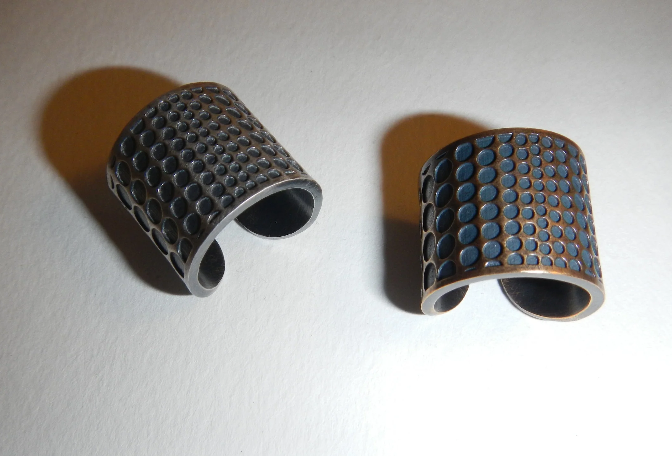 silver and bronze op art cigar band rings