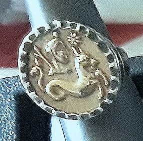 Gold Zodiac rings designed by Rhoma Young. Each ring’s center is all hand cast gold that’s recycled and made from an impression of antique French buttons. The outside is also all hand cast and hammered by an expert goldsmith. Price Group A