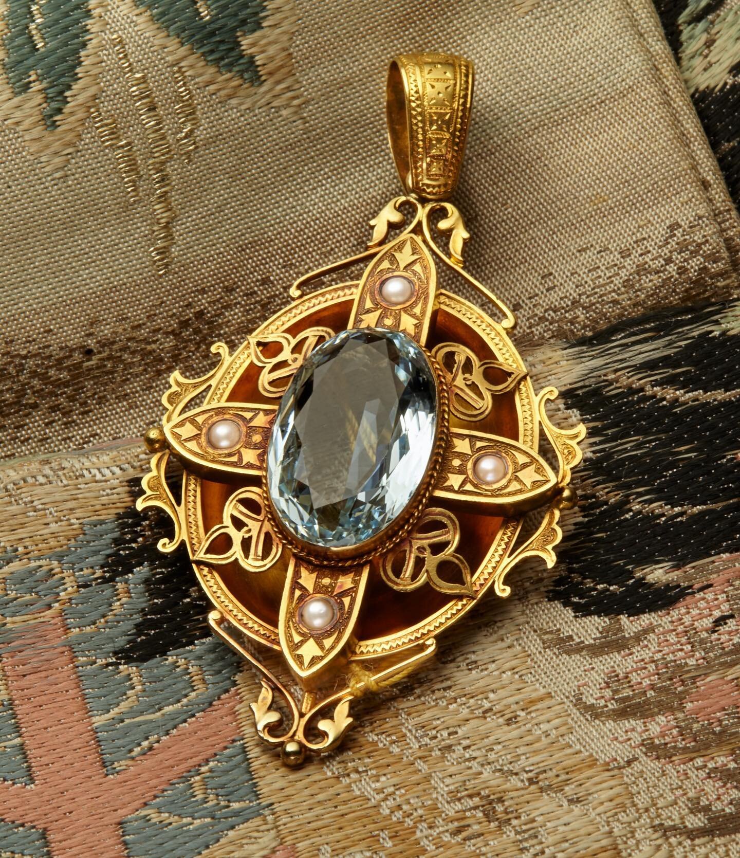 The aquamarine center of this is so beautifully cut and the saturation of color in the stone is spectacular! Gracefully mounted in romantic gold with a setting highlighted by pearls. This is graceful, charming and beautiful on a striking gold chain. 