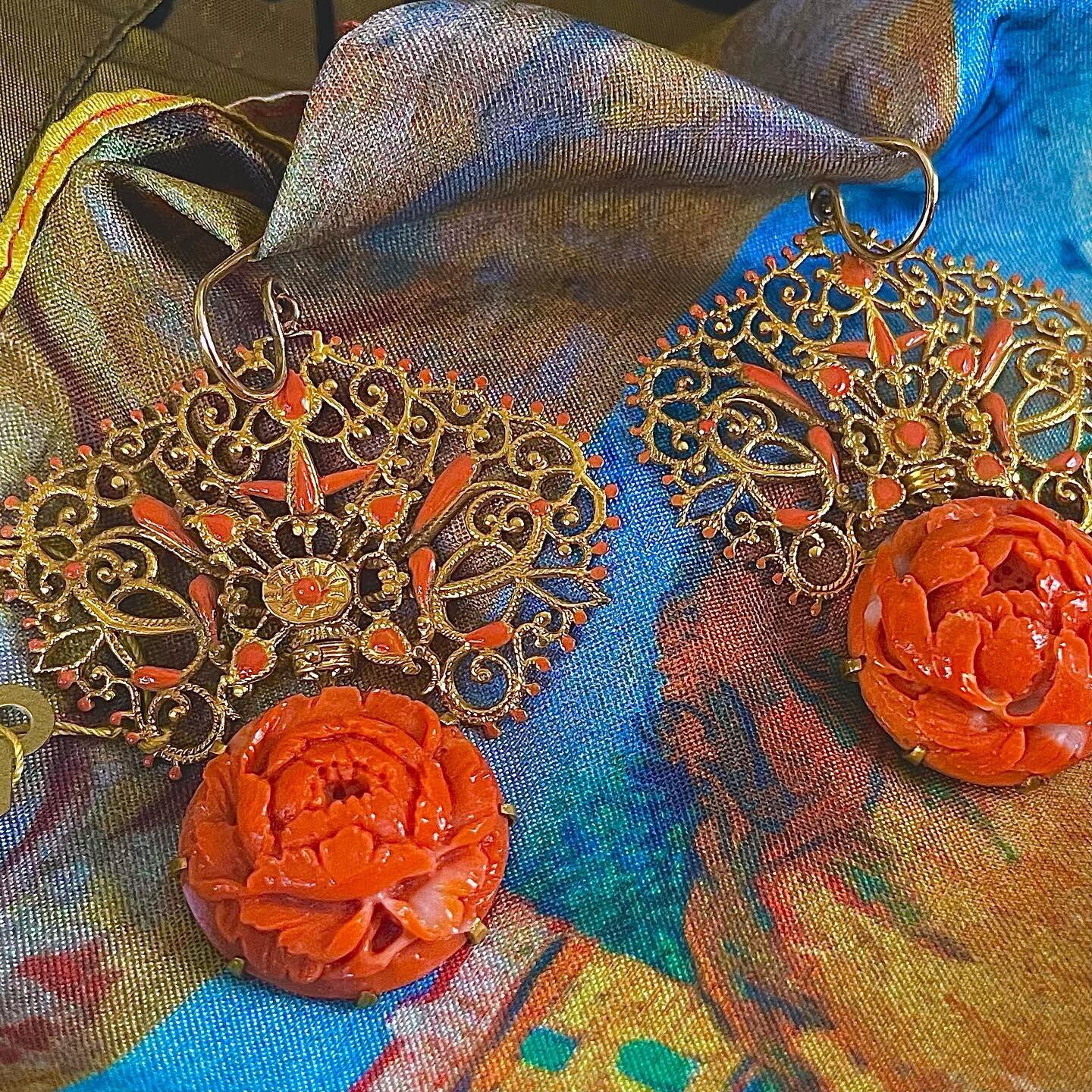 These extraordinary earrings were custom made to reflect the delicacy and richness of the gold in the tops highlighted by enamel in circling a beautifully carved coral flower. The two items of gold and coral offset each other and are rich, historic a