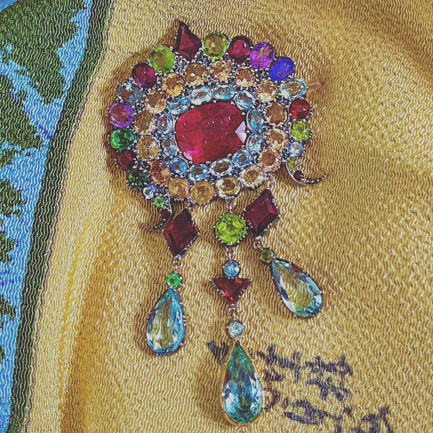 Glorious color and richness highlight this Indian turban ornament. It has aquamarine, garnet, tourmaline citrine, and sapphire. It is elegant, and sets apart the wire from a normal turbine we were if there is such a thing. This is 19th century, with 