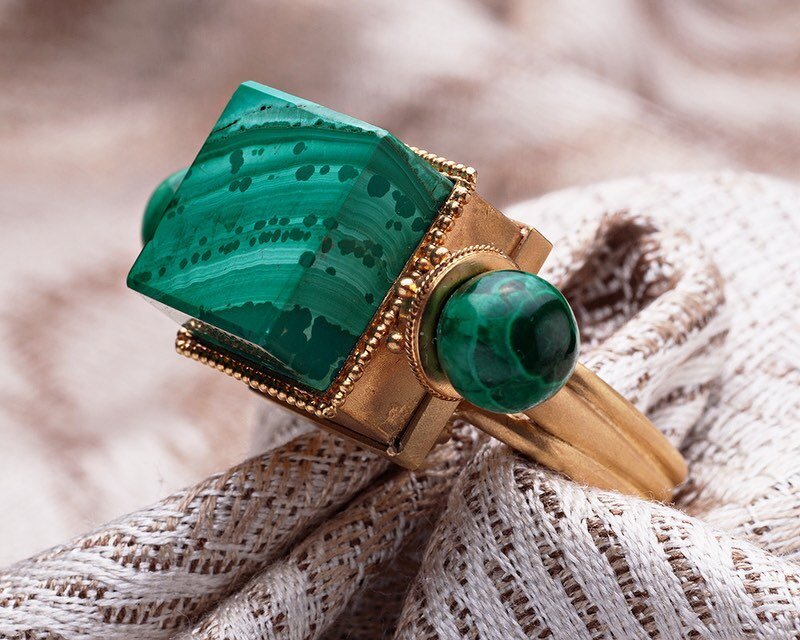 Non-traditional geometric shapes and positioning in this ring, make this unusual piece stand out as a harbinger of Modernism.&nbsp; The contrast of the richness of the gold and the intensity of the green of the stone complement and showcase the uniqu