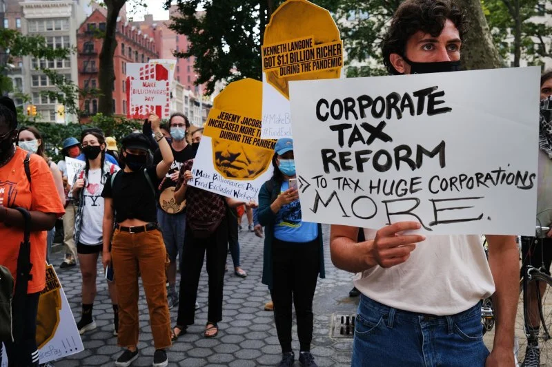 People participate in a "March on Billionaires" event on July 17 in New York City. The march called on Governor Andrew Cuomo to pass a tax on billionaires and to fund workers excluded from unemployment and federal aid programs (Spencer Platt—Getty I…