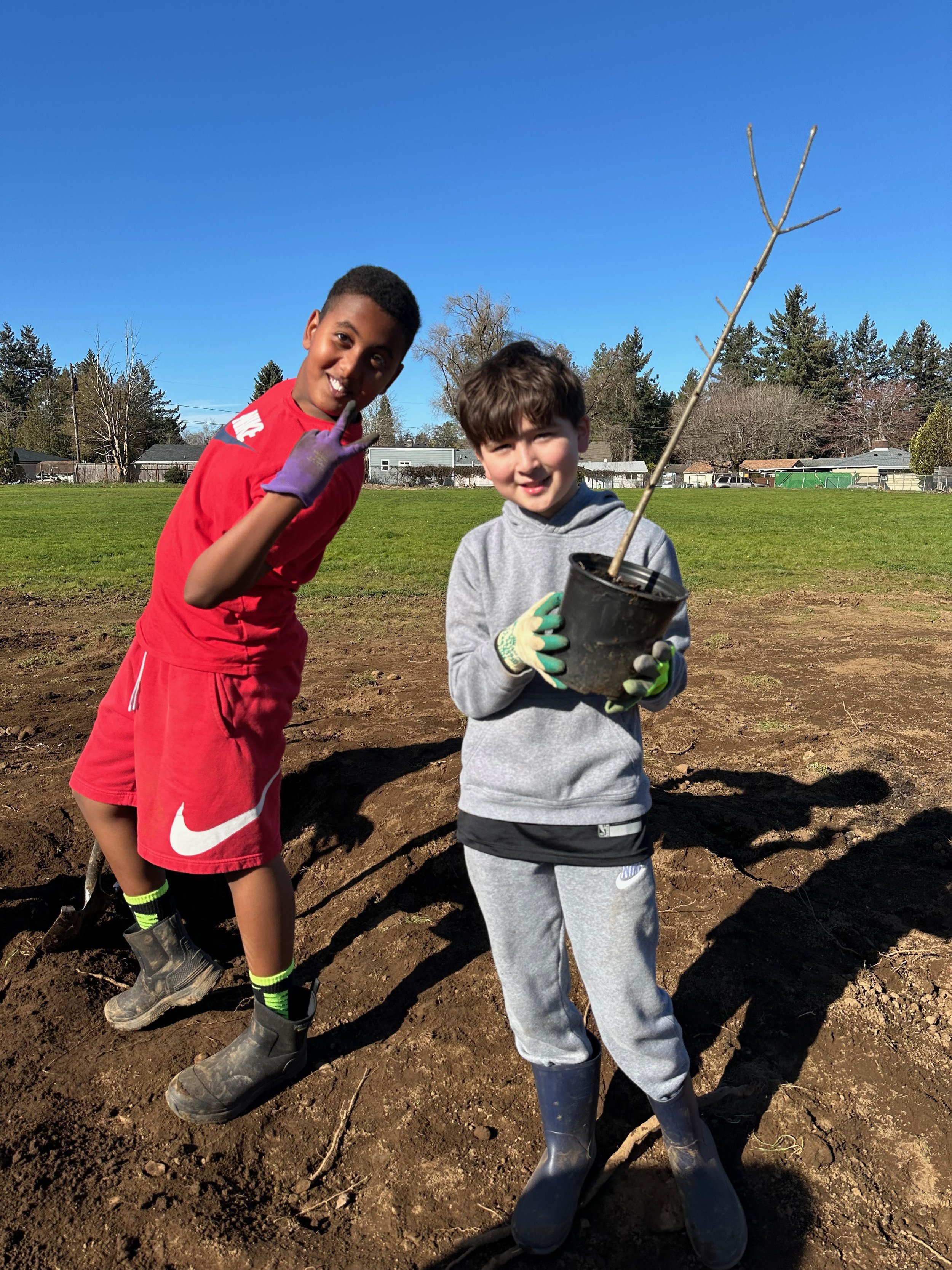 Two FMES students preparing to plant their special, self-chosen tree