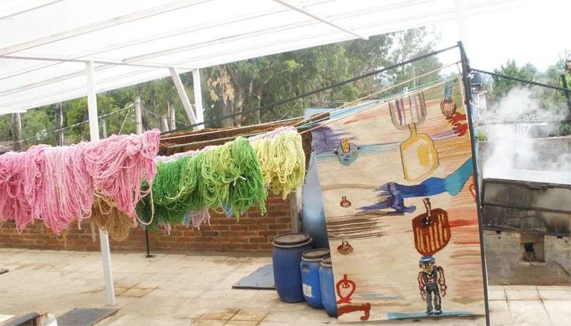 The process of dyeing wool in a steaming vat. Skeins drying and finished Custom rug designed by artist Andrew Saftel