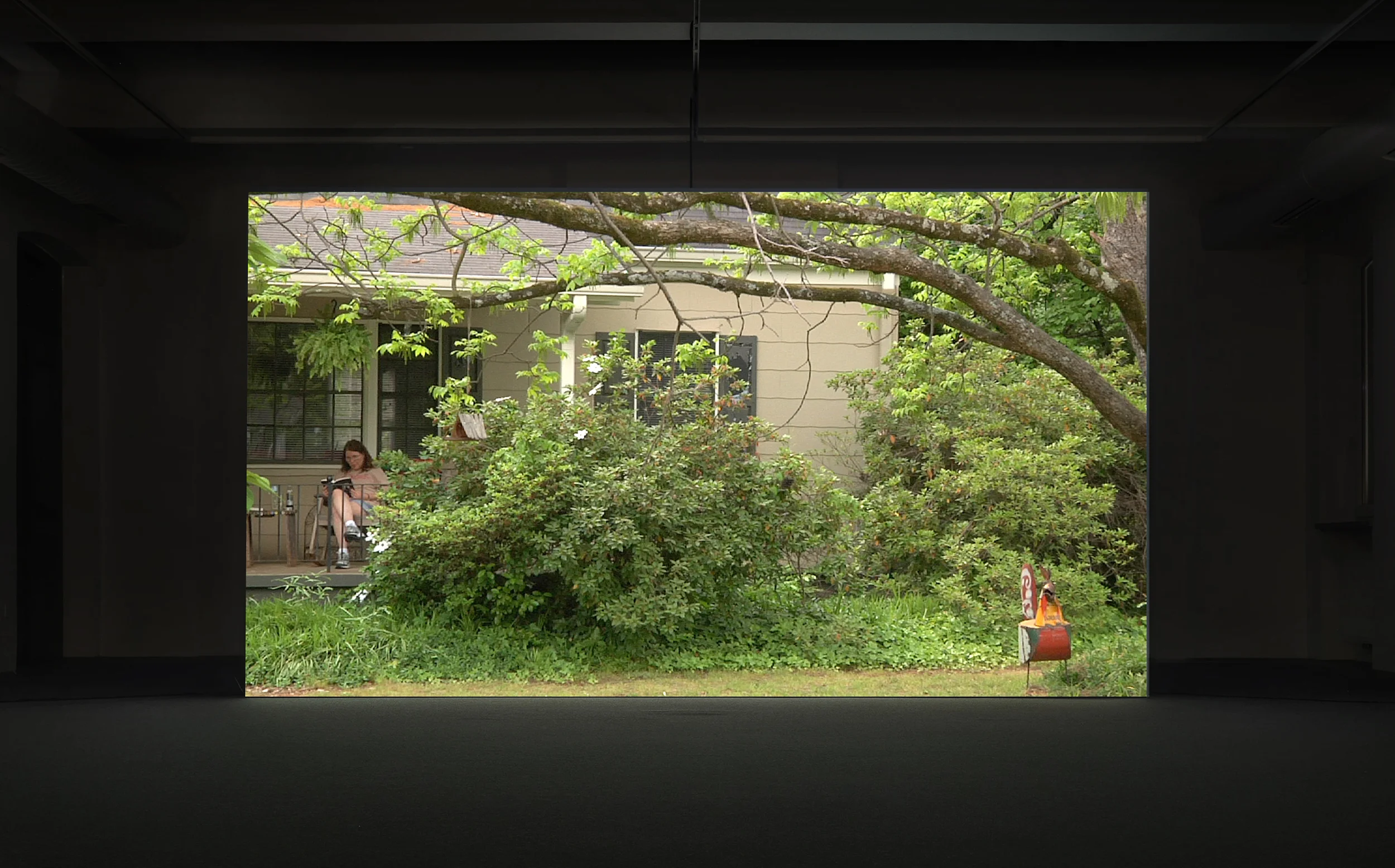 Normal Town , 2012. Installation view , Video projection, 06:30 minutes, loop. The work focuses on the departure of a military base in the residential neighborhood: Normal Town, located in Athens Georgia, USA. Tobačna 001 cultural center, Ljubljana, Slovenia. A solo exhibition as a part of an artist residency program, Curated by: Alenka Trebušak.