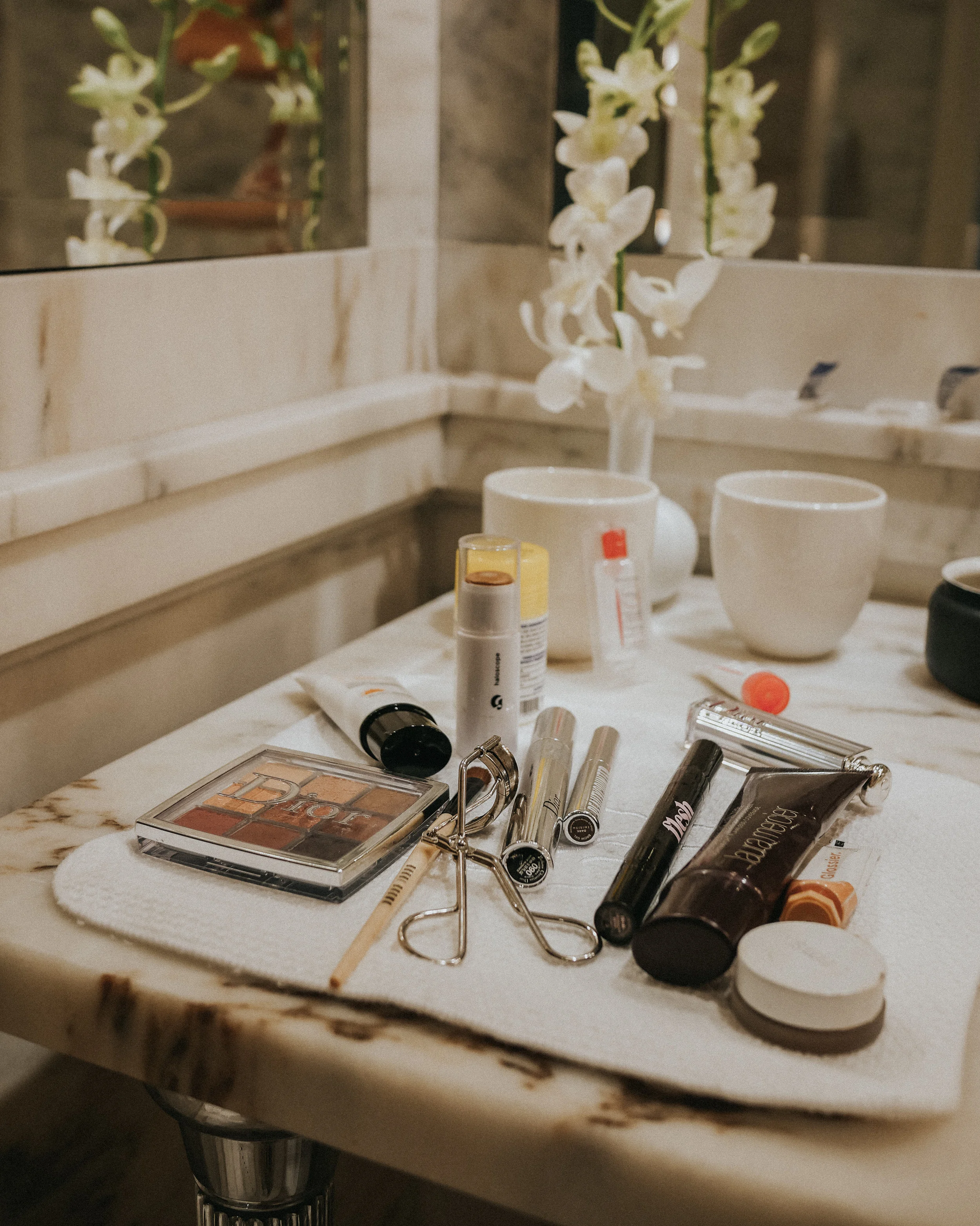 Essentials only! Dior Backstage Eyeshadow Palette, Belif Sunscreen, Glossier Haloscope, Flesh concealer, Laura Mercier Tinted Moisturizer, RMS Beauty Bronzer, Dior Snow Lipstick, Glossier Cloud Paint in Haze.