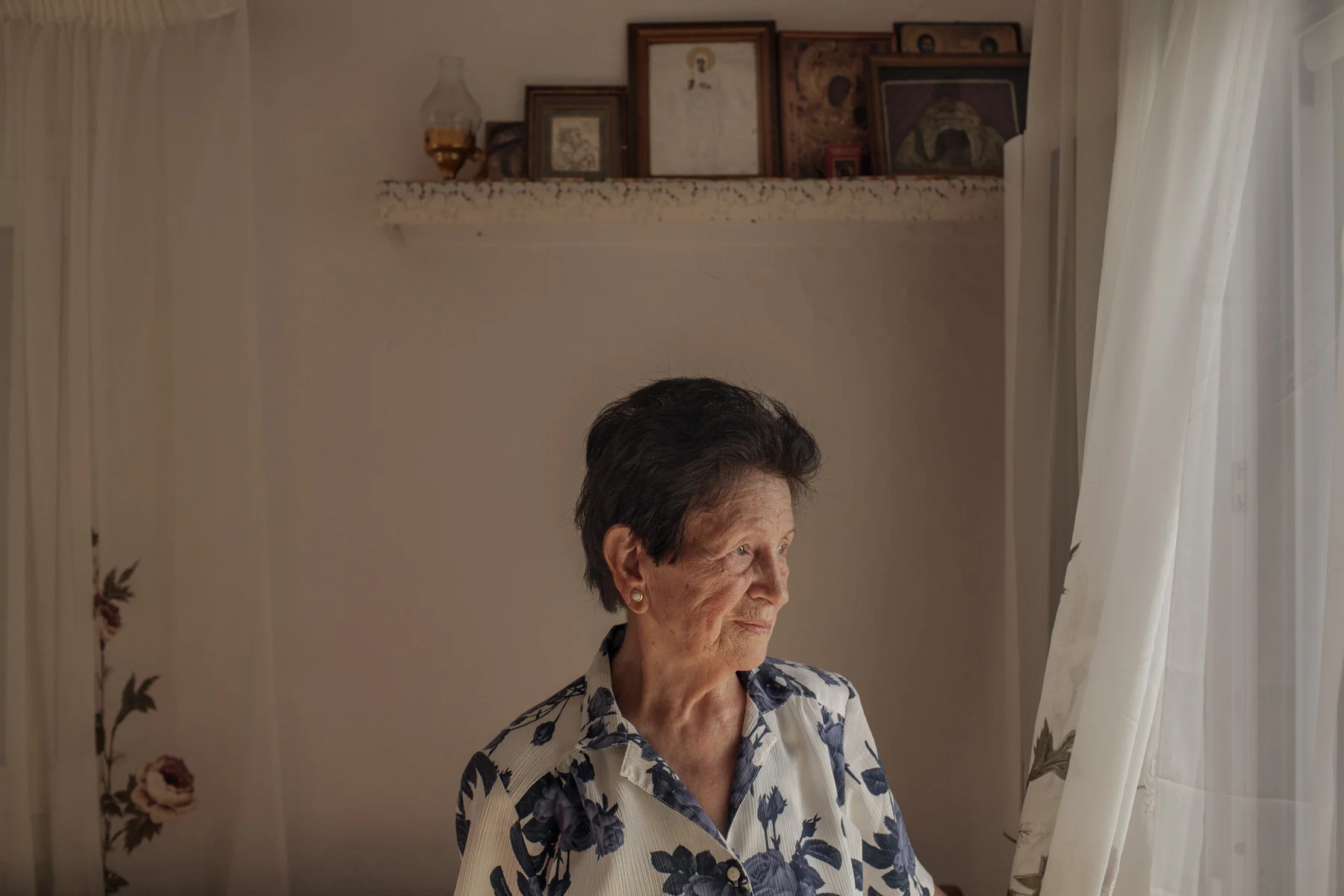 Konstantina Mpalli stands for a portrait in her home in Skala Sykamineas on the island of Lesbos, Greece. In 2015, when thousands of refugees arrived daily on the shores around Skala Sykamineas, Mpalli helped by bringing them food and looking after their children. 