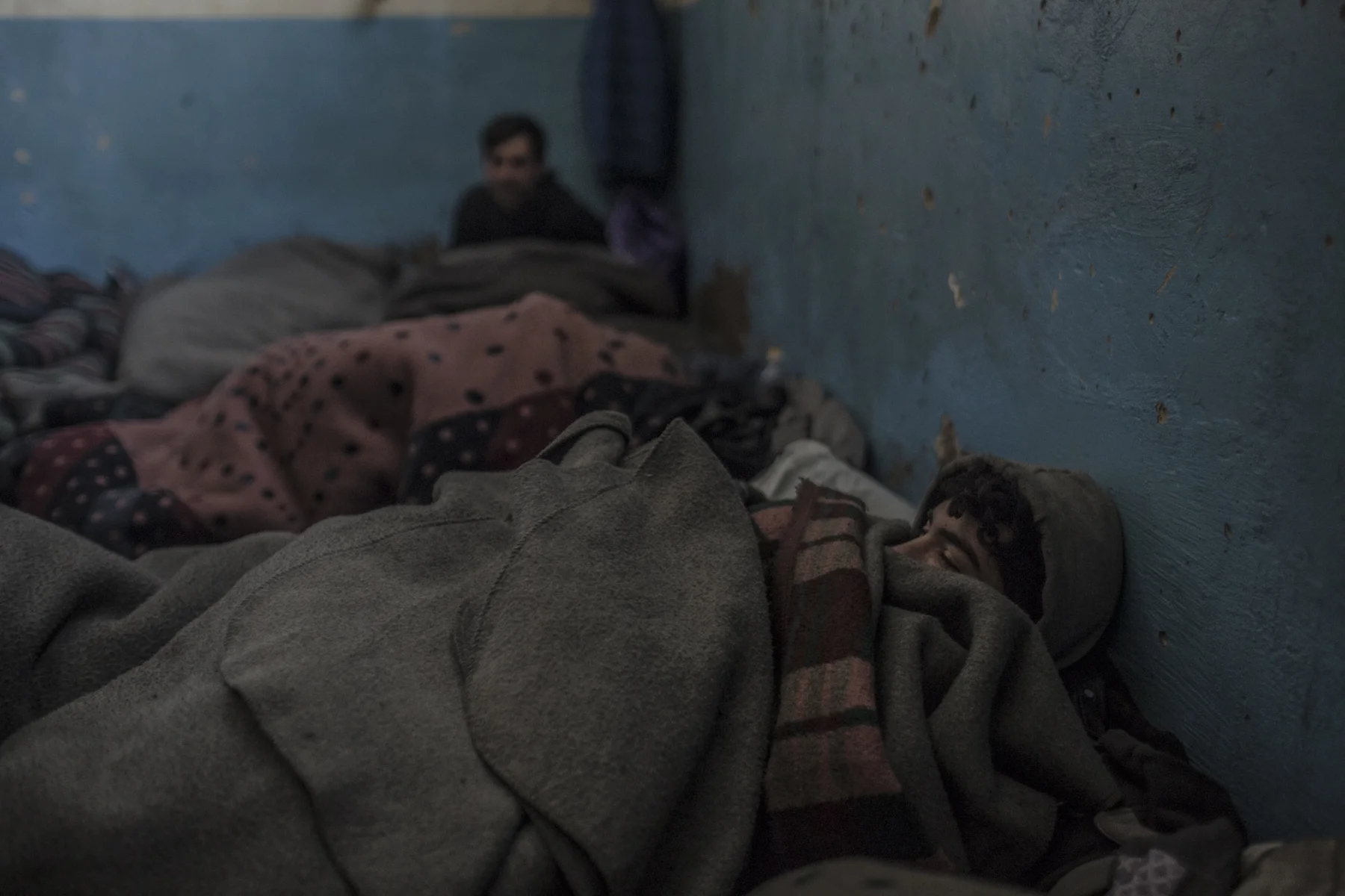 Afghan refugees sleep in an abandoned warehouse behind the main train station of Belgrade.