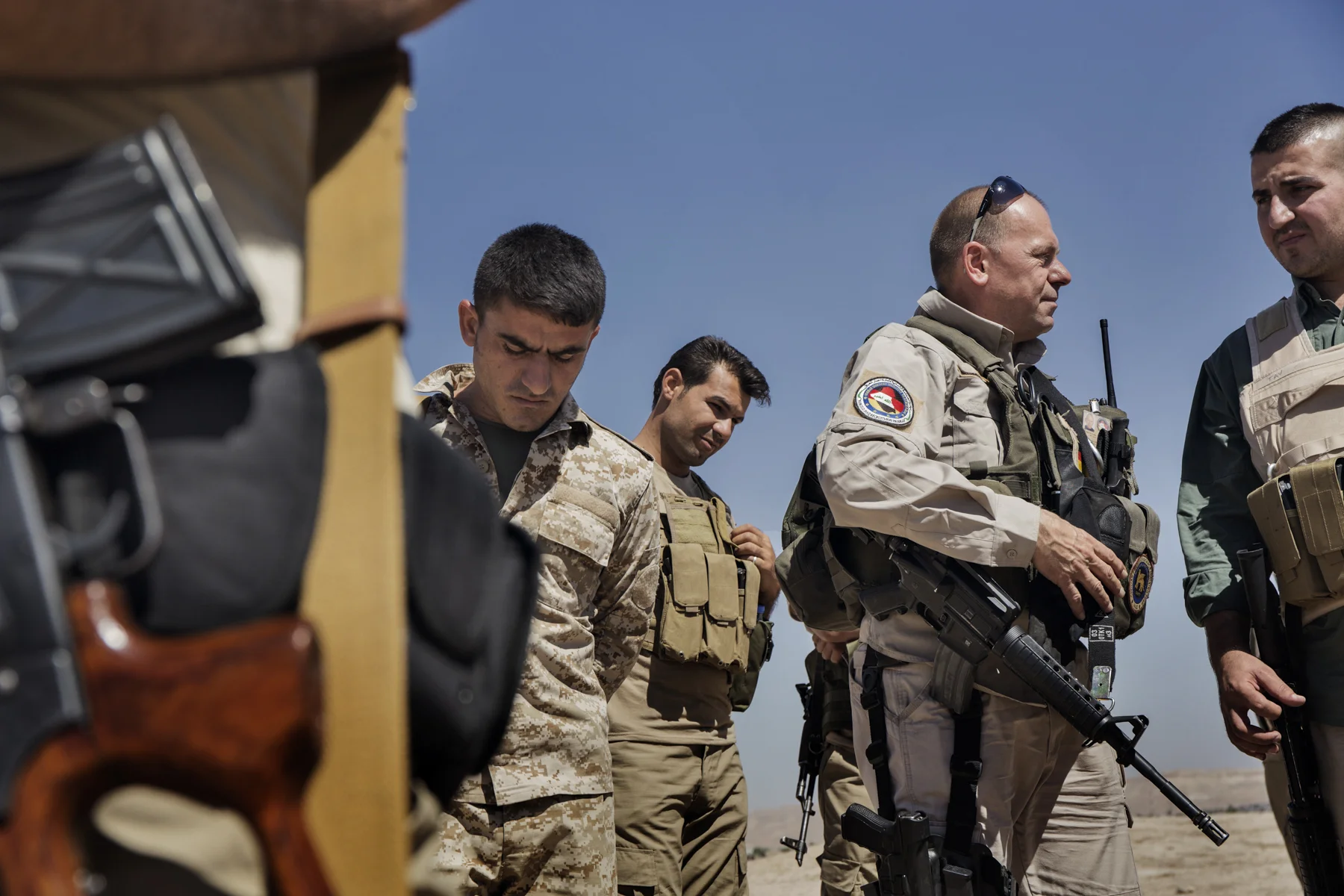 The CEO of a German private security company talks to Peshmerga at their base in Makhmour, Iraq.