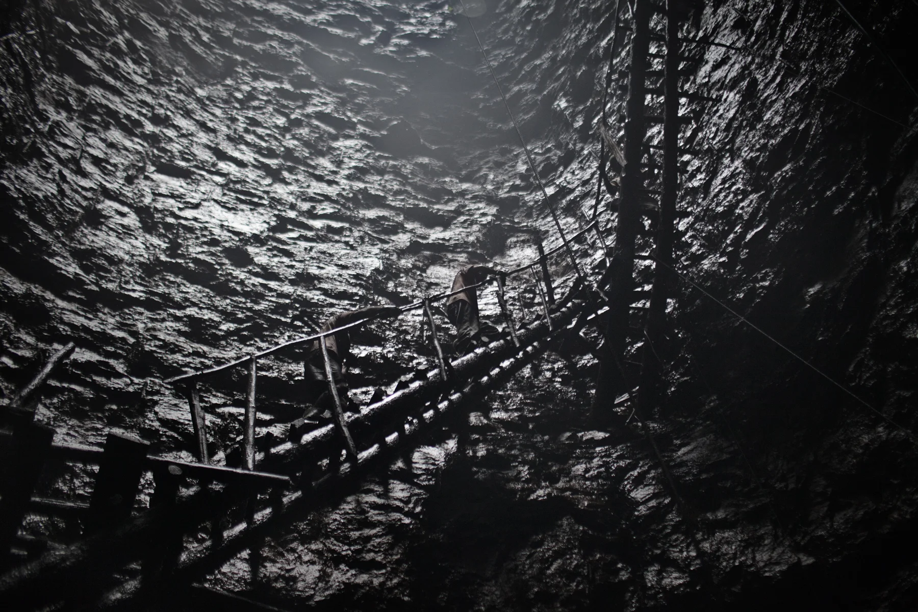 Coal miners walk out of a quarry in the Jaintia Hills.