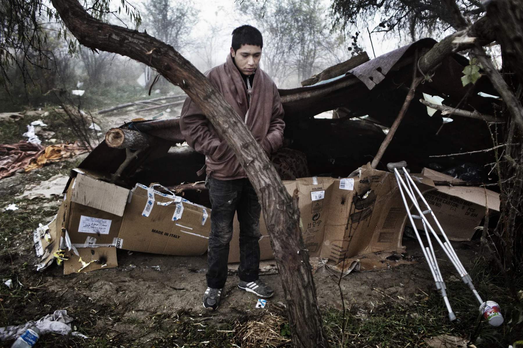 Kabir, an underaged Afghan refugee, wakes up after a night in a makeshift camp that was partly destroyed by police, Subotica, Serbia. 