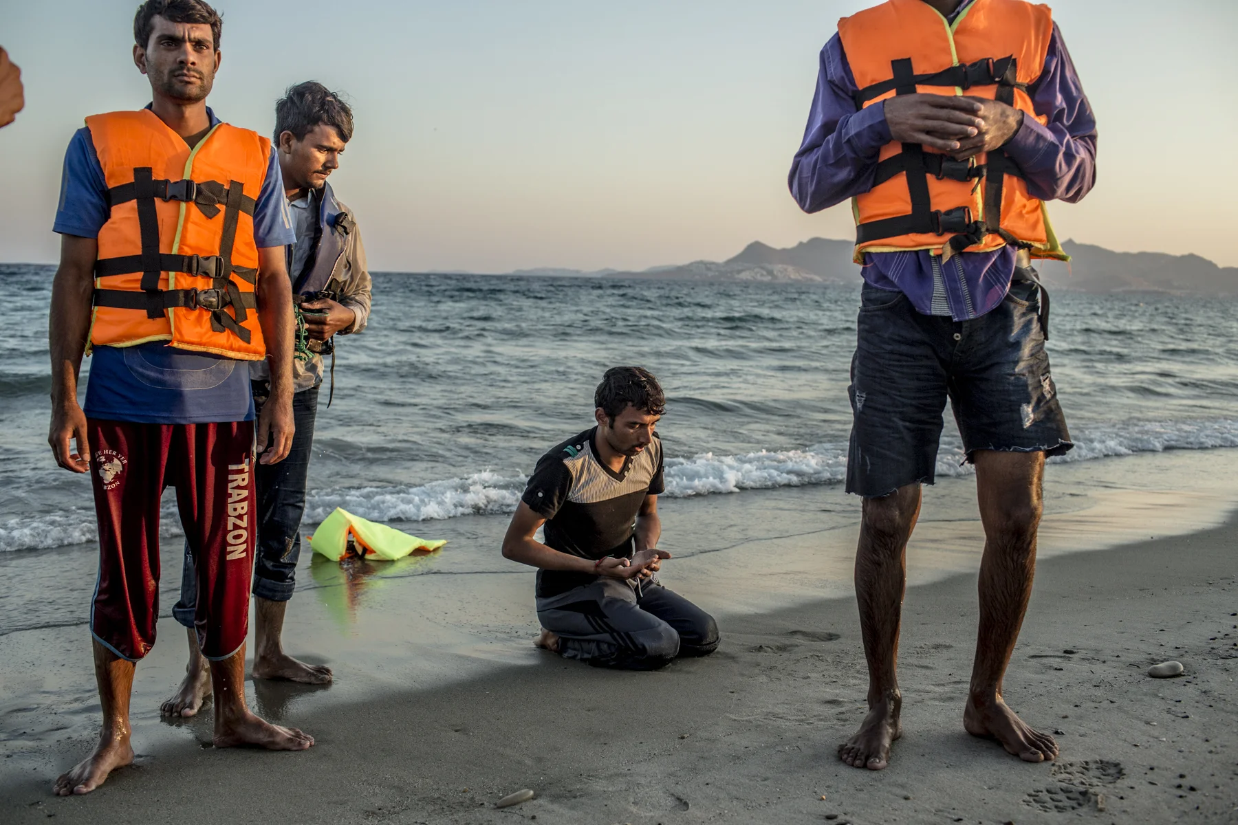 Pakistan migrants pray on a beach on the Greek island of Kos. 