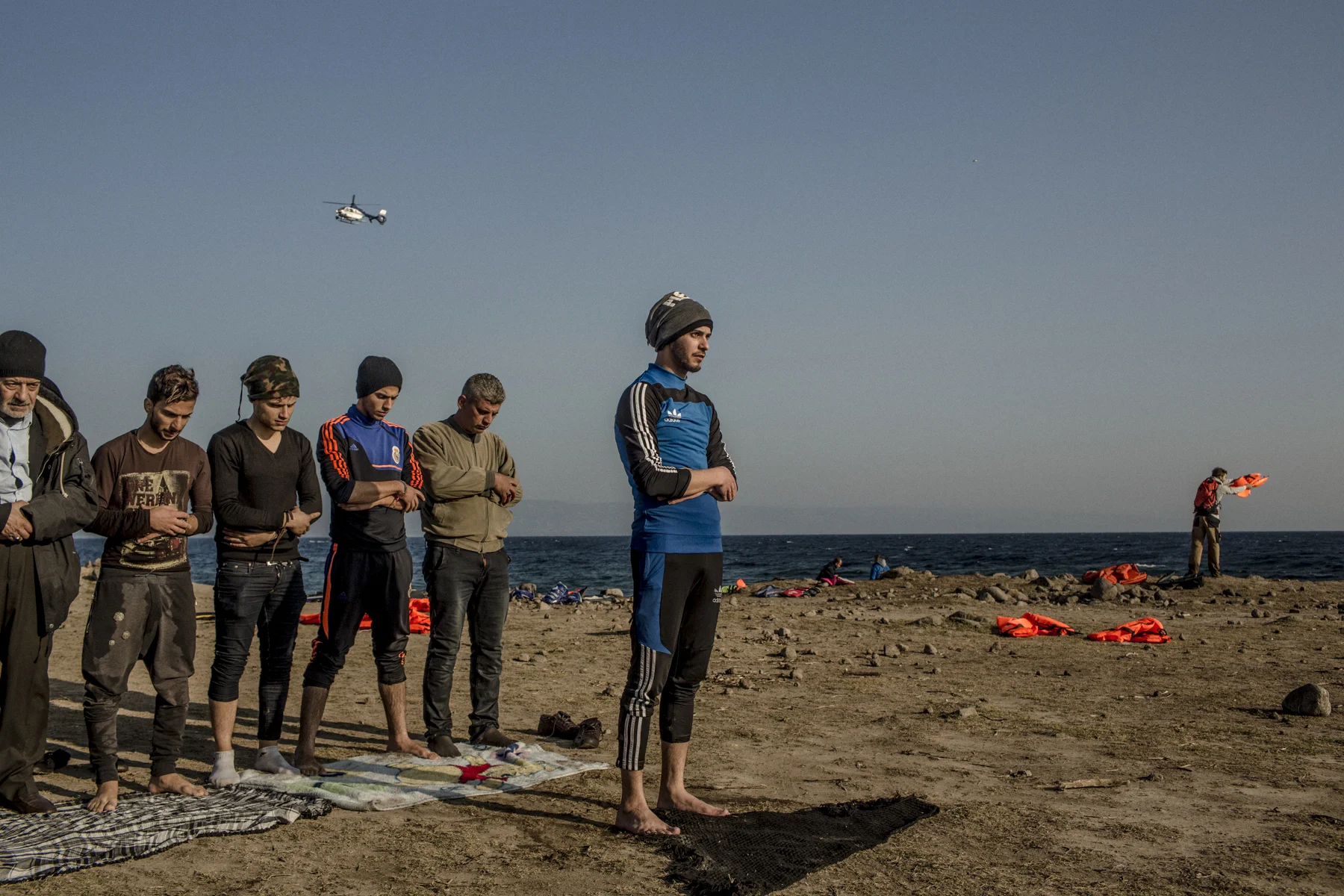 Syrian men pray on a beach on the Greek island of Lesbos. 