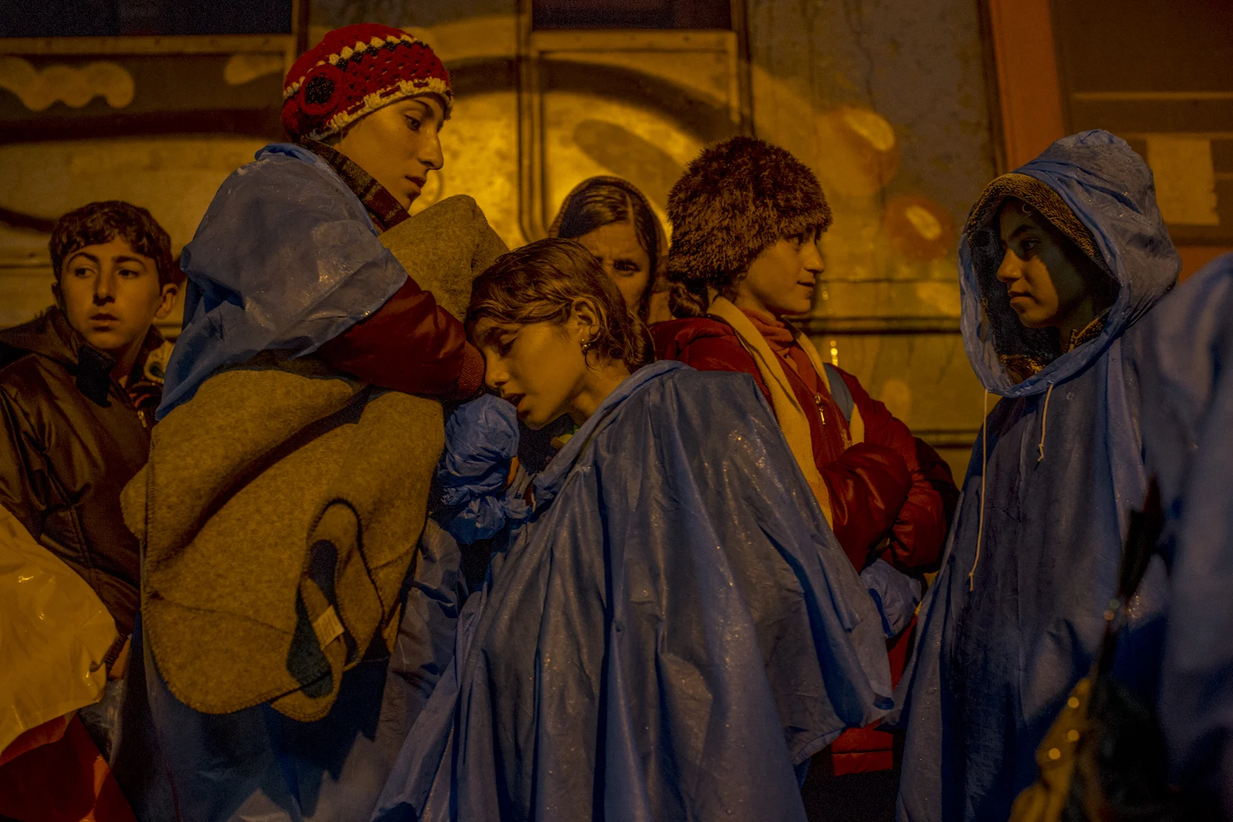 A Yazidi family waits at a train station in Serbia. 