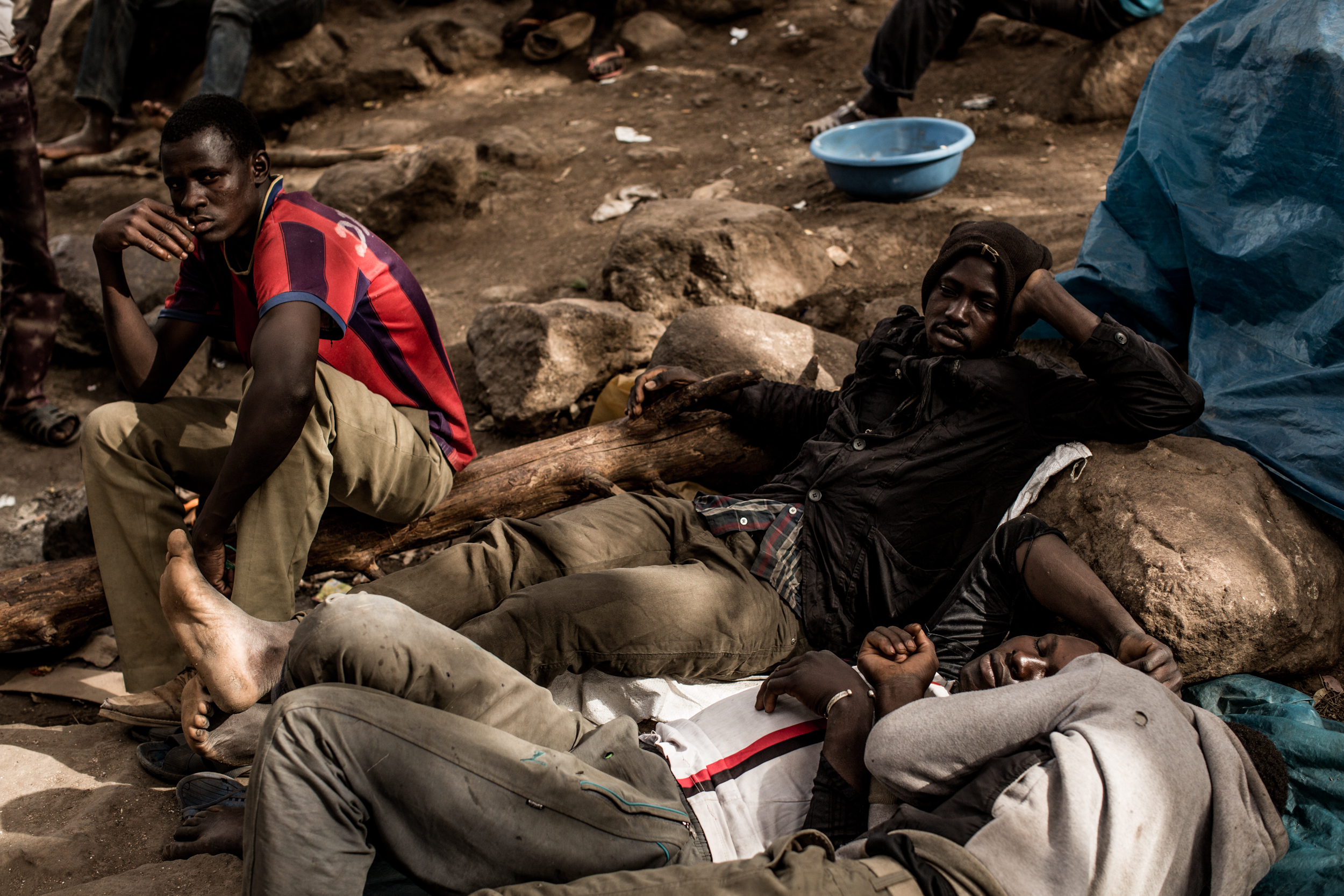 Men rest in the camp.