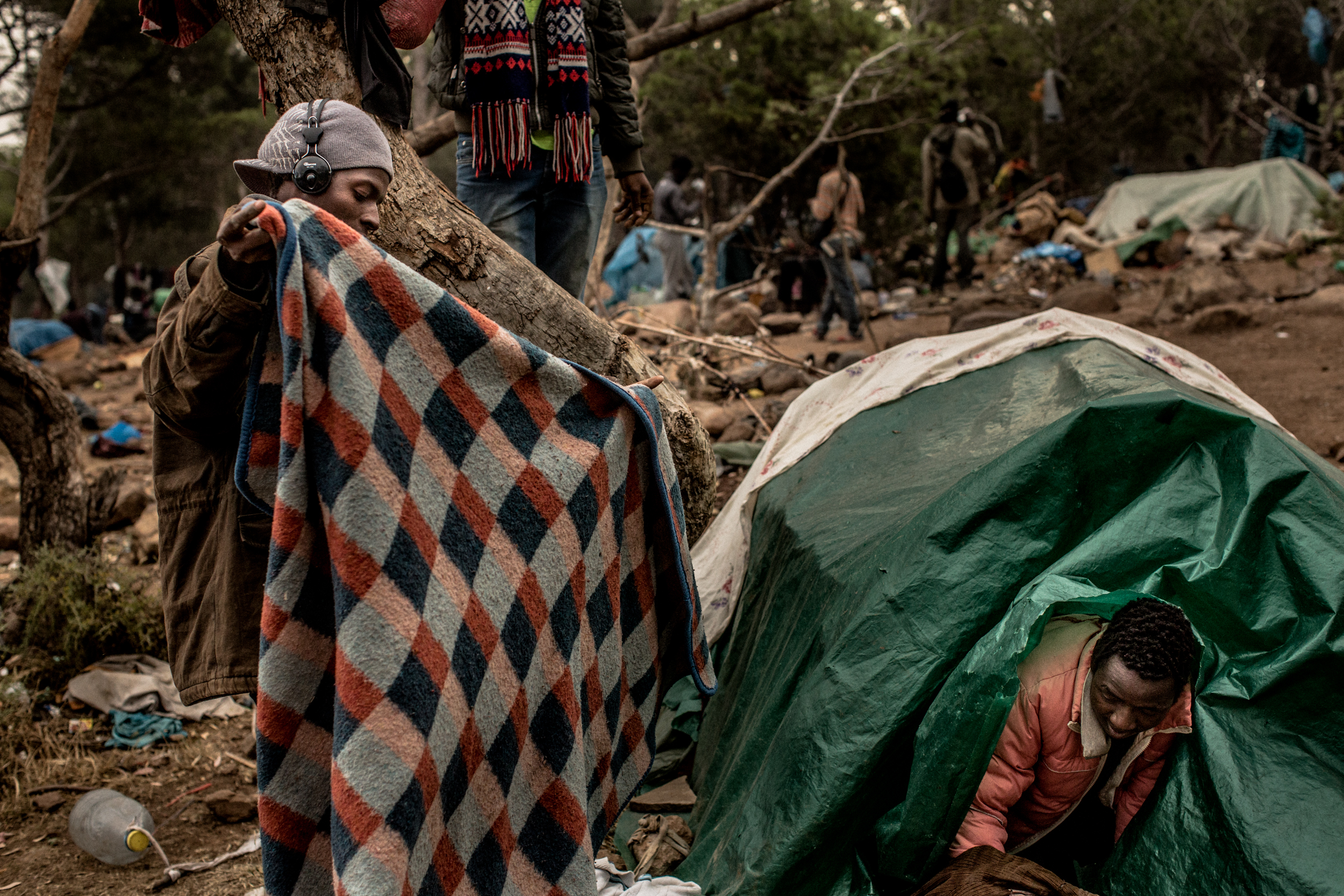 Two men set up their tent after the fled from a rumored police raid that did not happen.