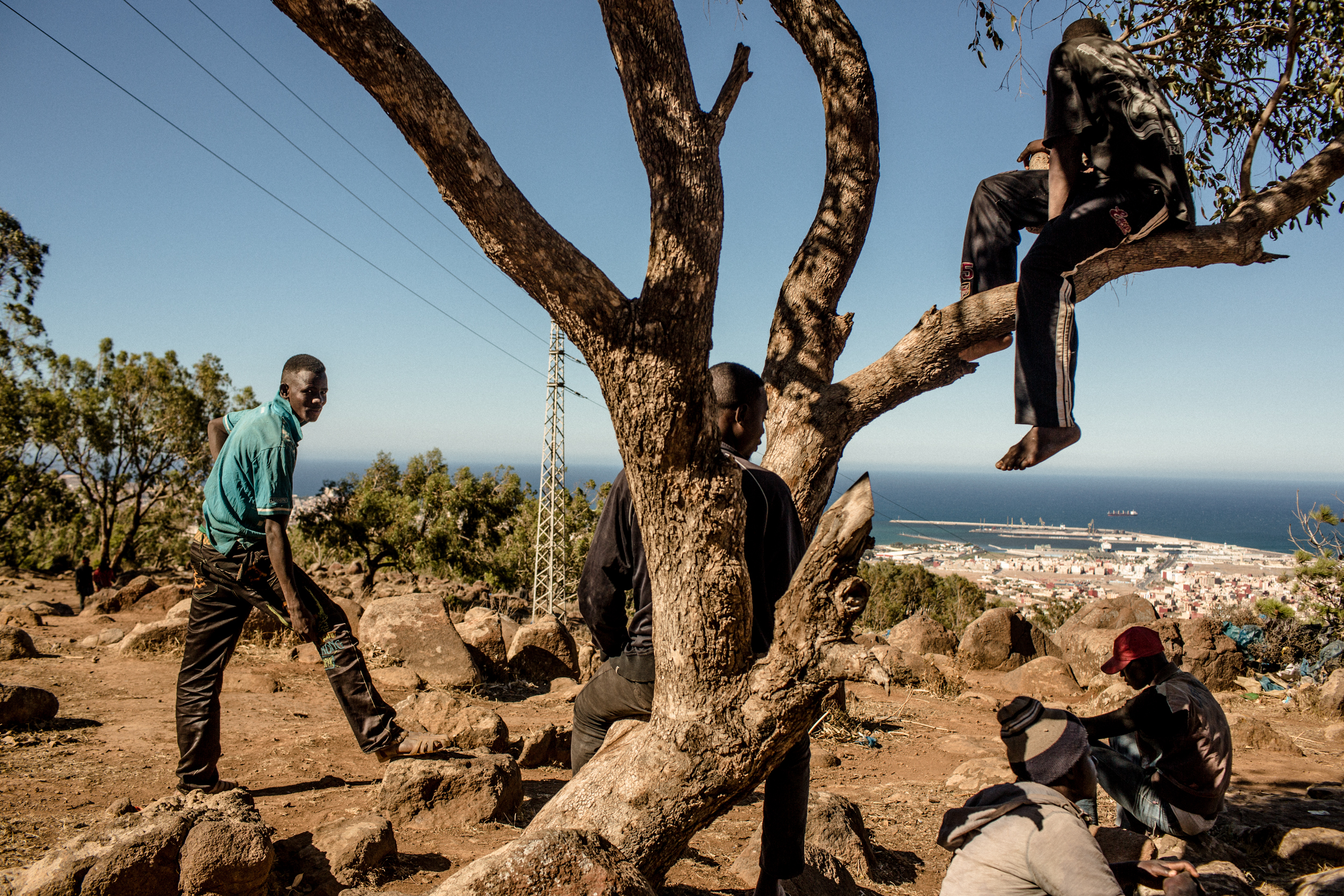 Malian migrants rest and wait on Gorougou Hill overlooking the Spanish exclave of Melilla.