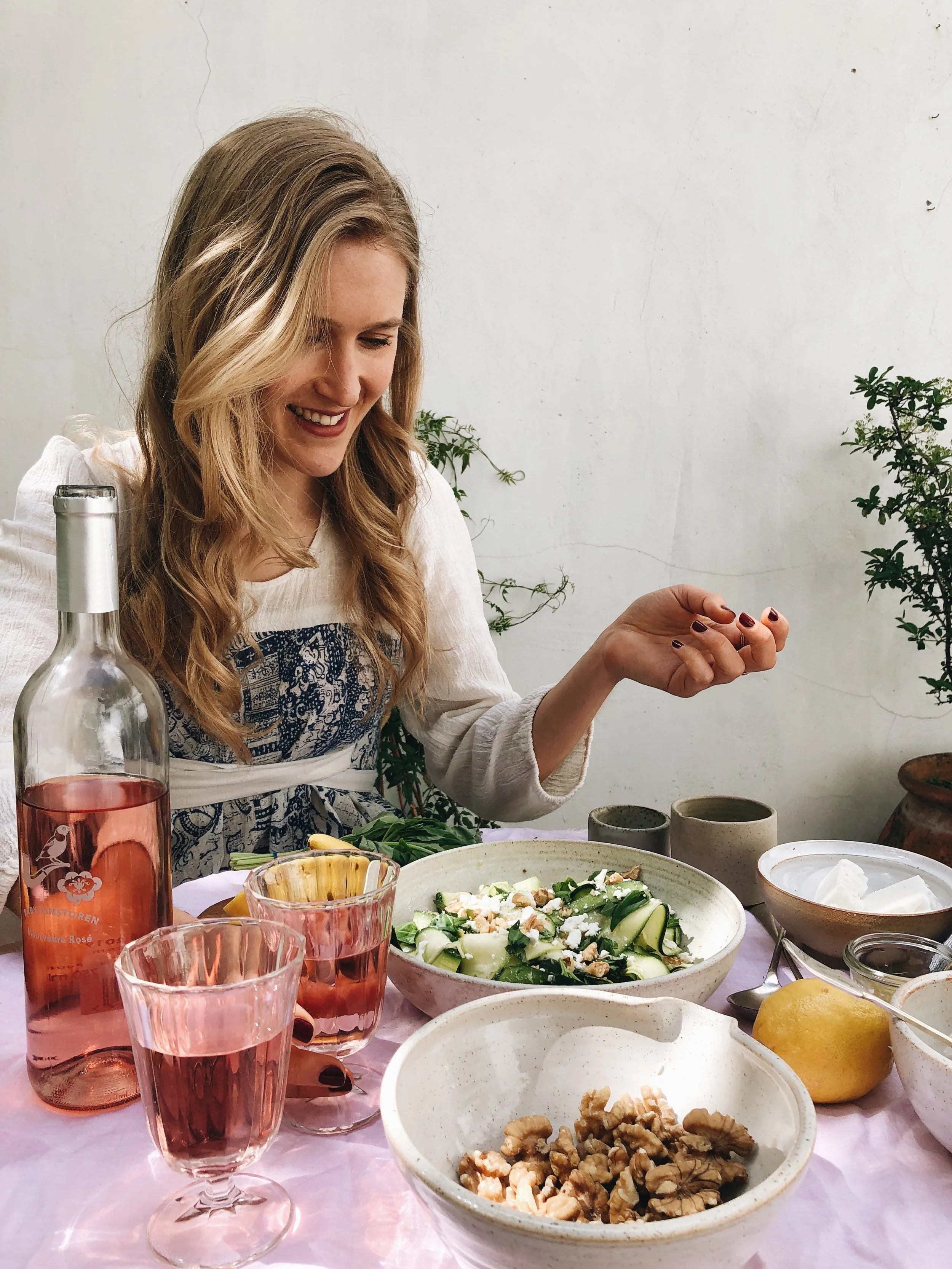 A glass of rosé and a summer salad