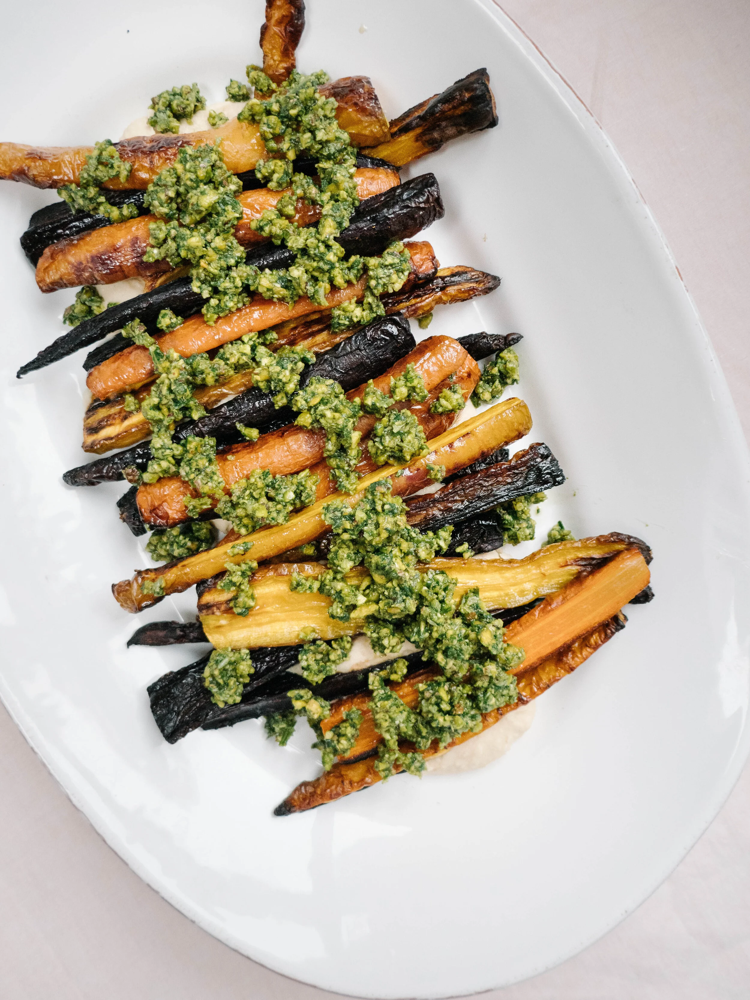 Roasted rainbow carrots on pureed lemony butterbeans with pistachio pesto. 