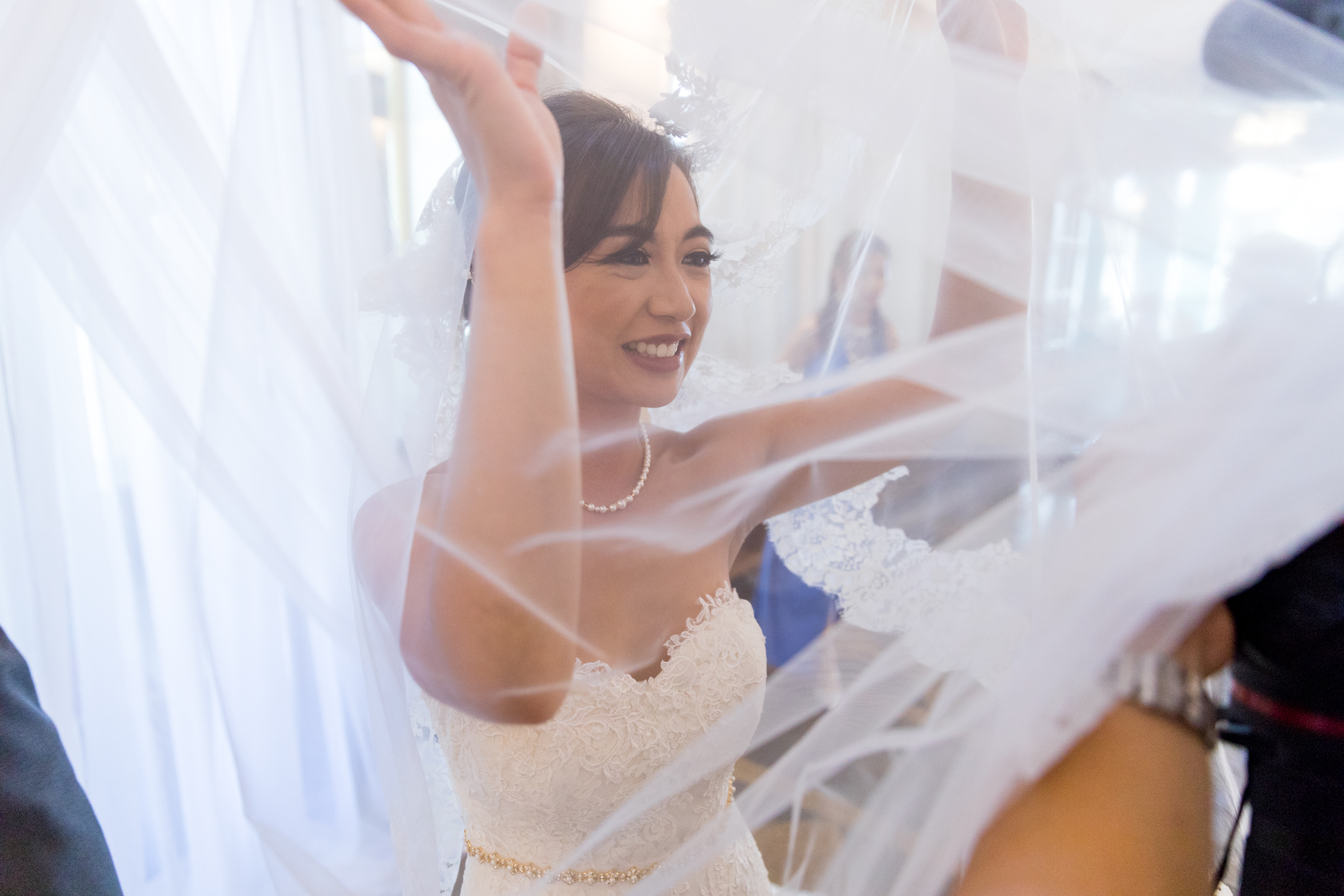 Bride Fun with Veil during Wedding Reception