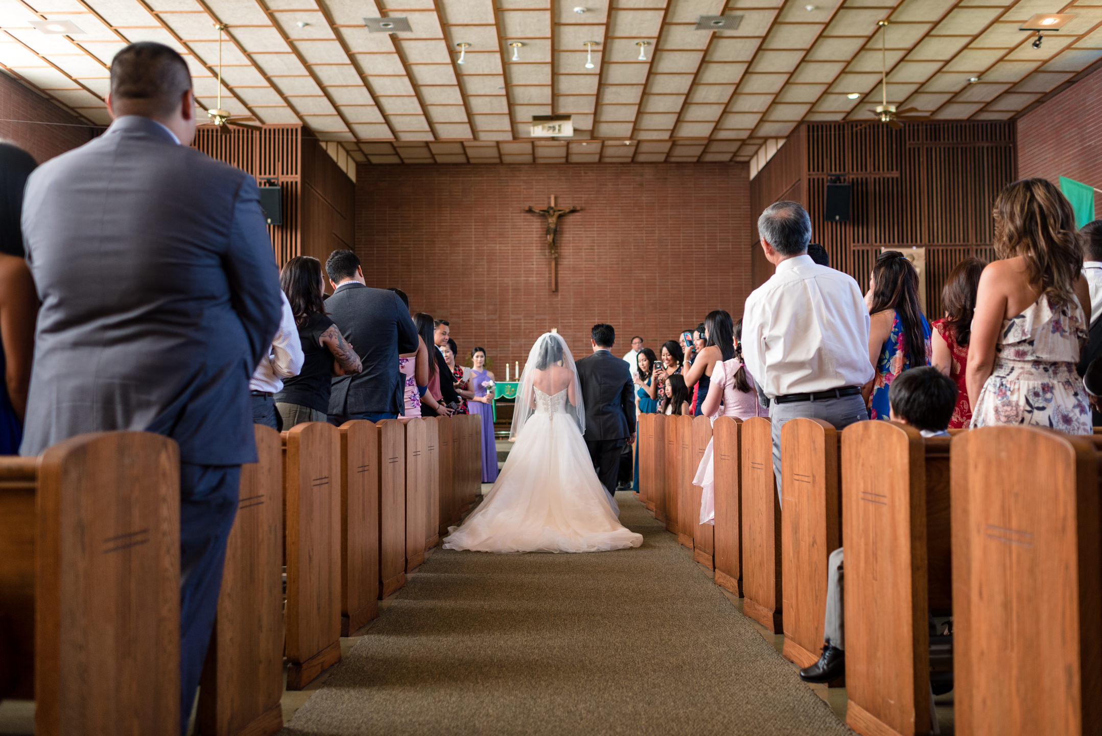 Asian Bride and Father Walk Down Aisle during Wedding Ceremony