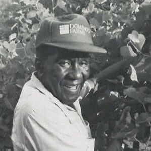 Booker T. Whatley smiling among the trees.