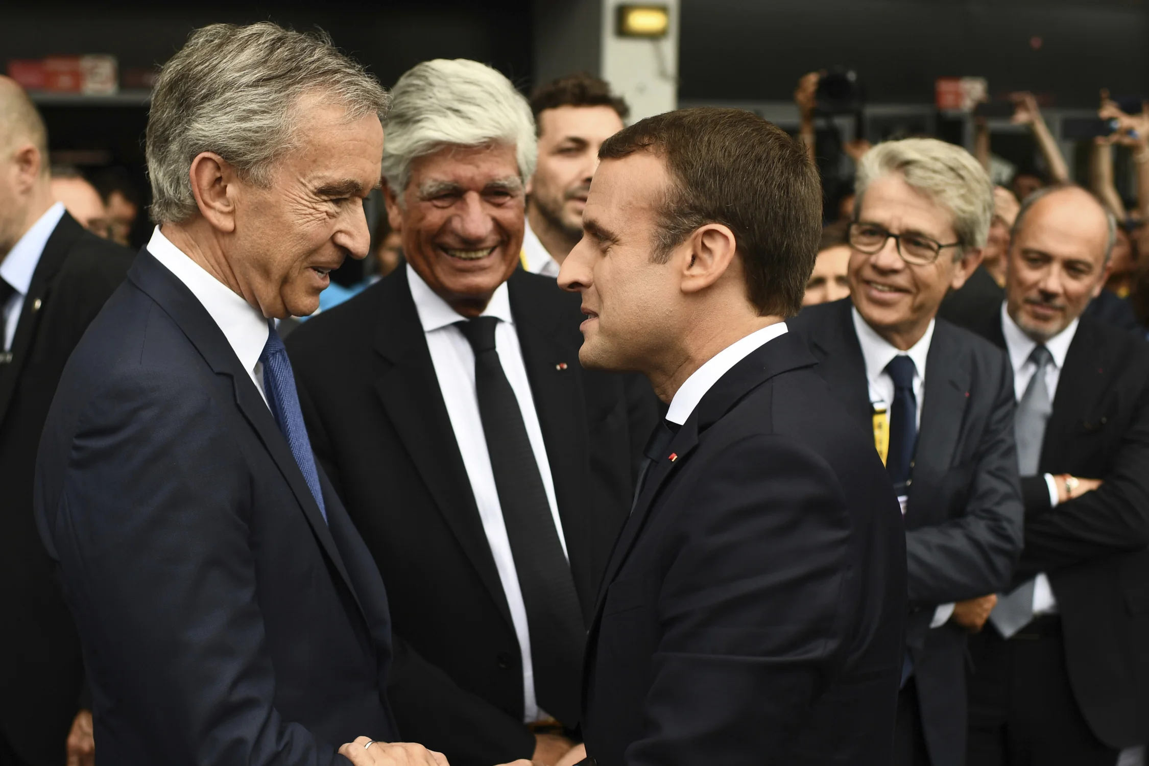 LVMH Group CEO Bernard Arnault (left) shakes the hand of French President Emmanuel Macron (right) at Vivatech // Image: Martin Bureau/Pool Photo via AP