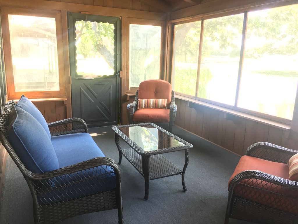 Screened in porch with wicker furniture