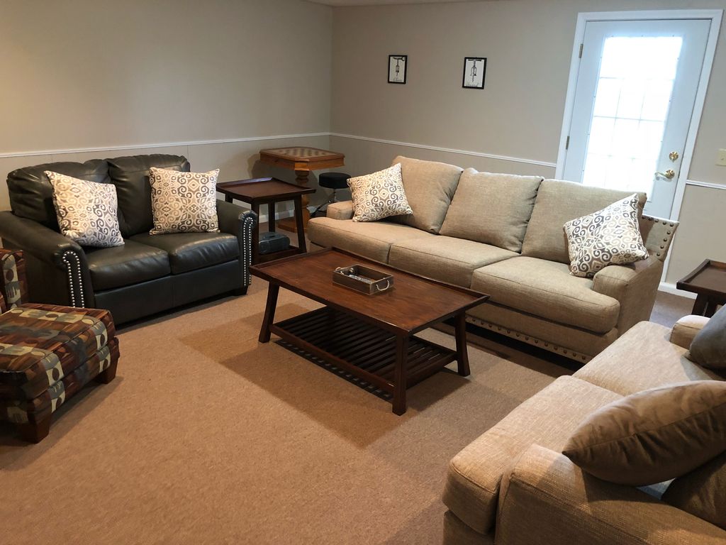 Man cave has a door that leads onto the back patio providing views of vineyard