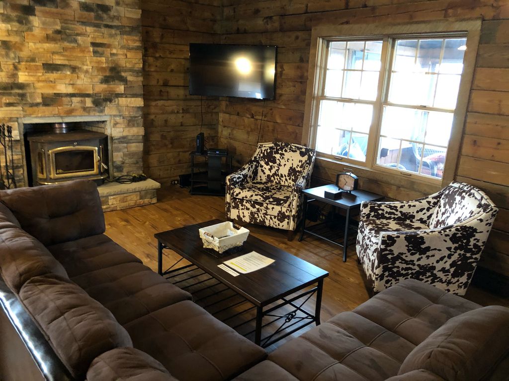 Living room has 50" TV and wood burning fireplace