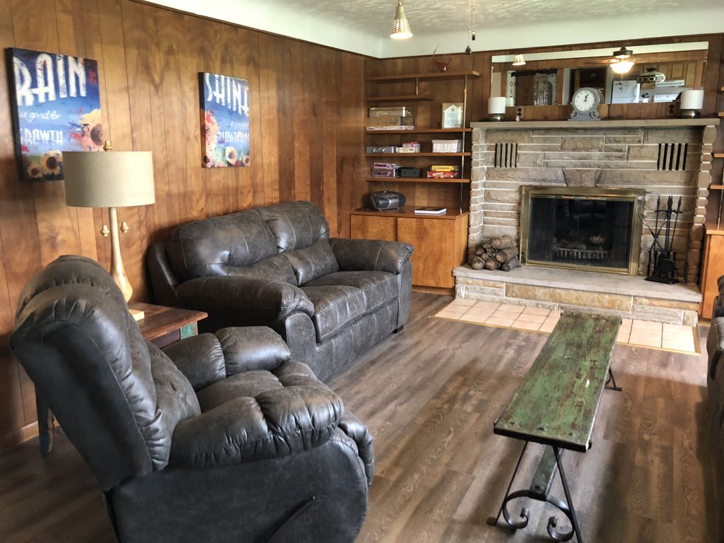 Living room features a wood burning fireplace