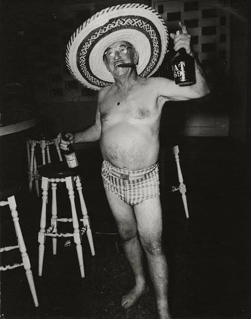Vintage holiday party photograph of an older man in a sombrero and festive attire, used as visual inspiration for the offbeat humor and retro tone of More Salt, More Acid.