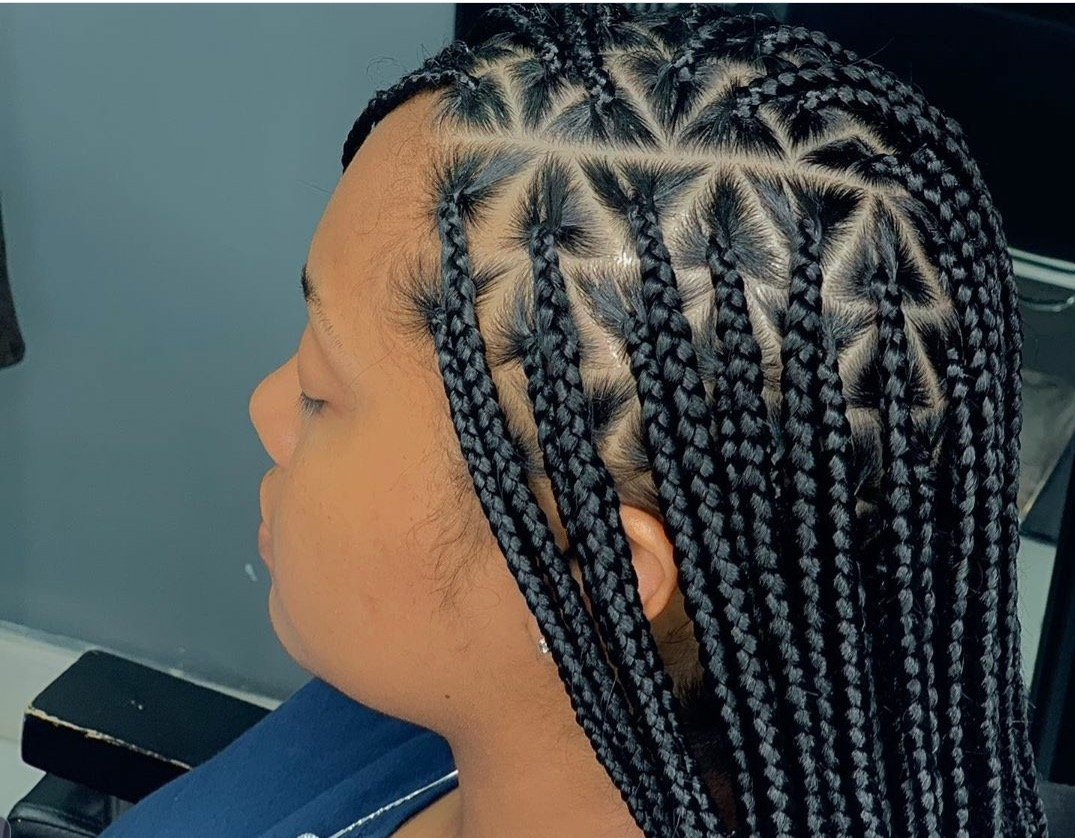 Close-up of a woman with neatly done black and silver box braids.