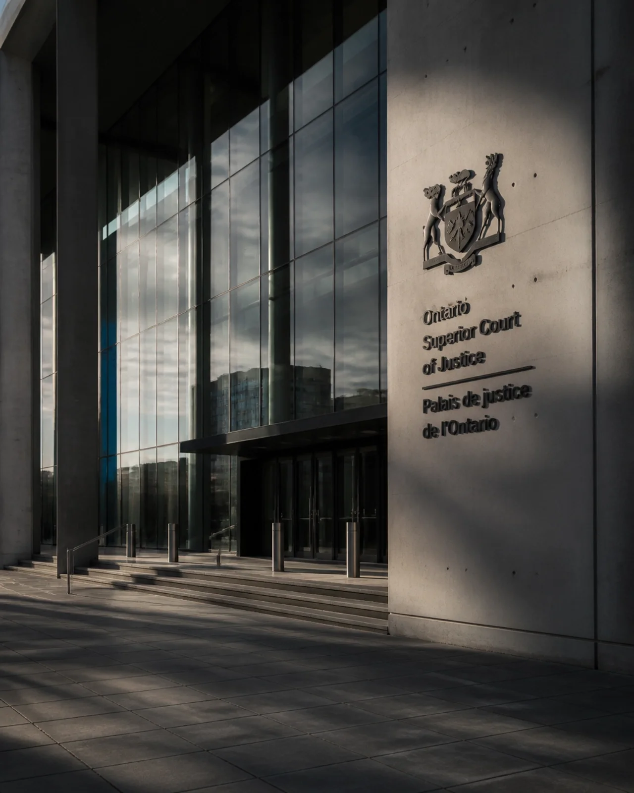 The modern architectural entrance of an Ontario Superior Court of Justice, symbolizing the legal process and authority.