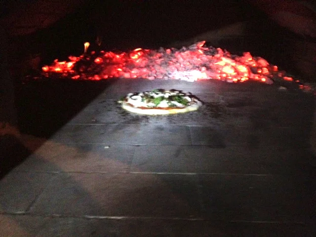 Our first pizza! Sorry for the bad picture - it is very hard to get good lighting inside a pizza oven.
