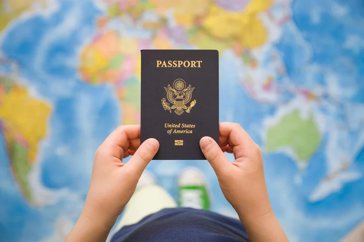 U.S. passport held over a world map