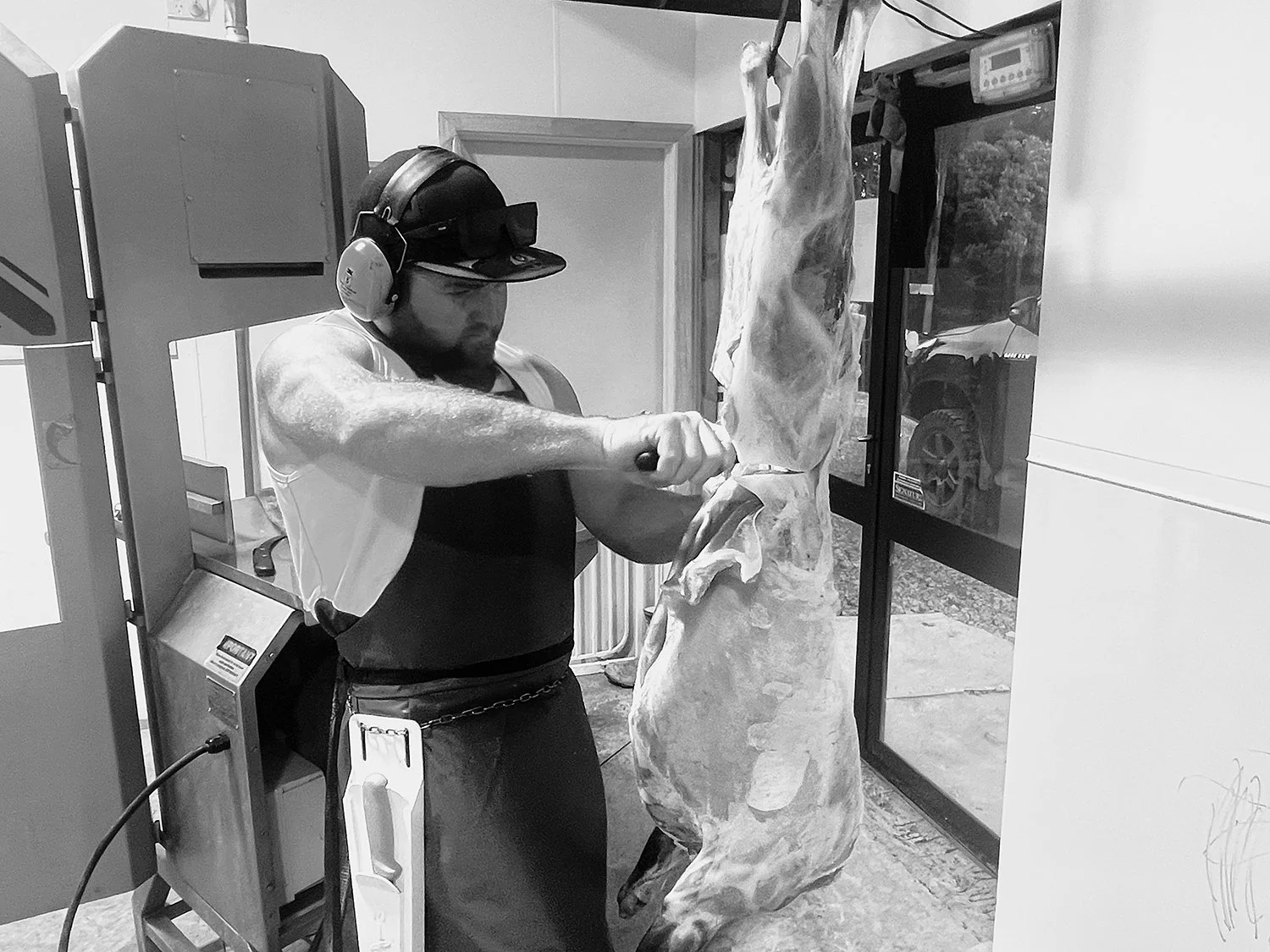 Butcher cutting a sheep carcase