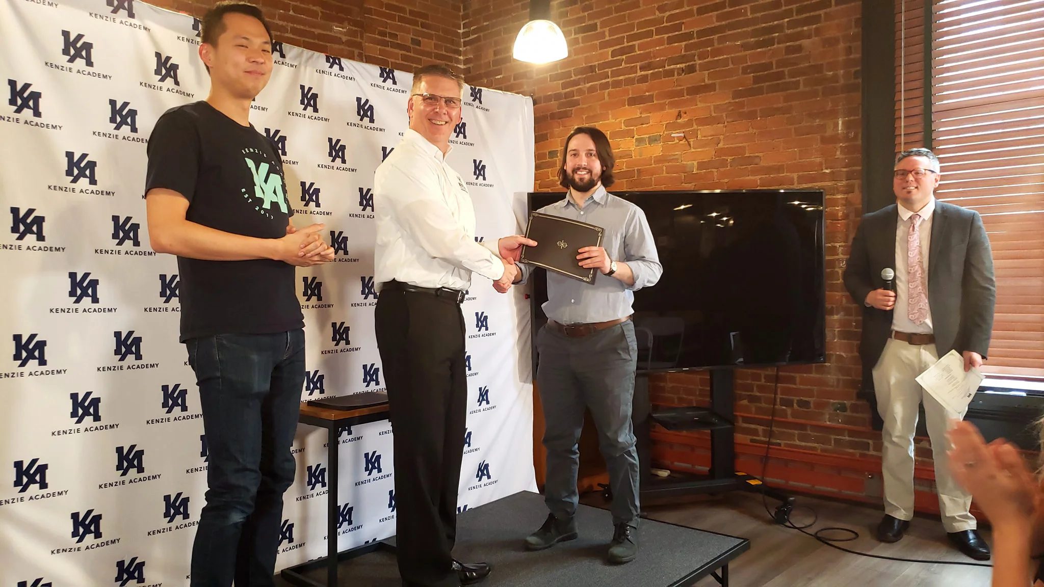 Butler’s Executive Director of Executive Education, William Gulley presenting a dual Kenzie/Butler certificate to Cohort 1 Graduate, Jake Berg.