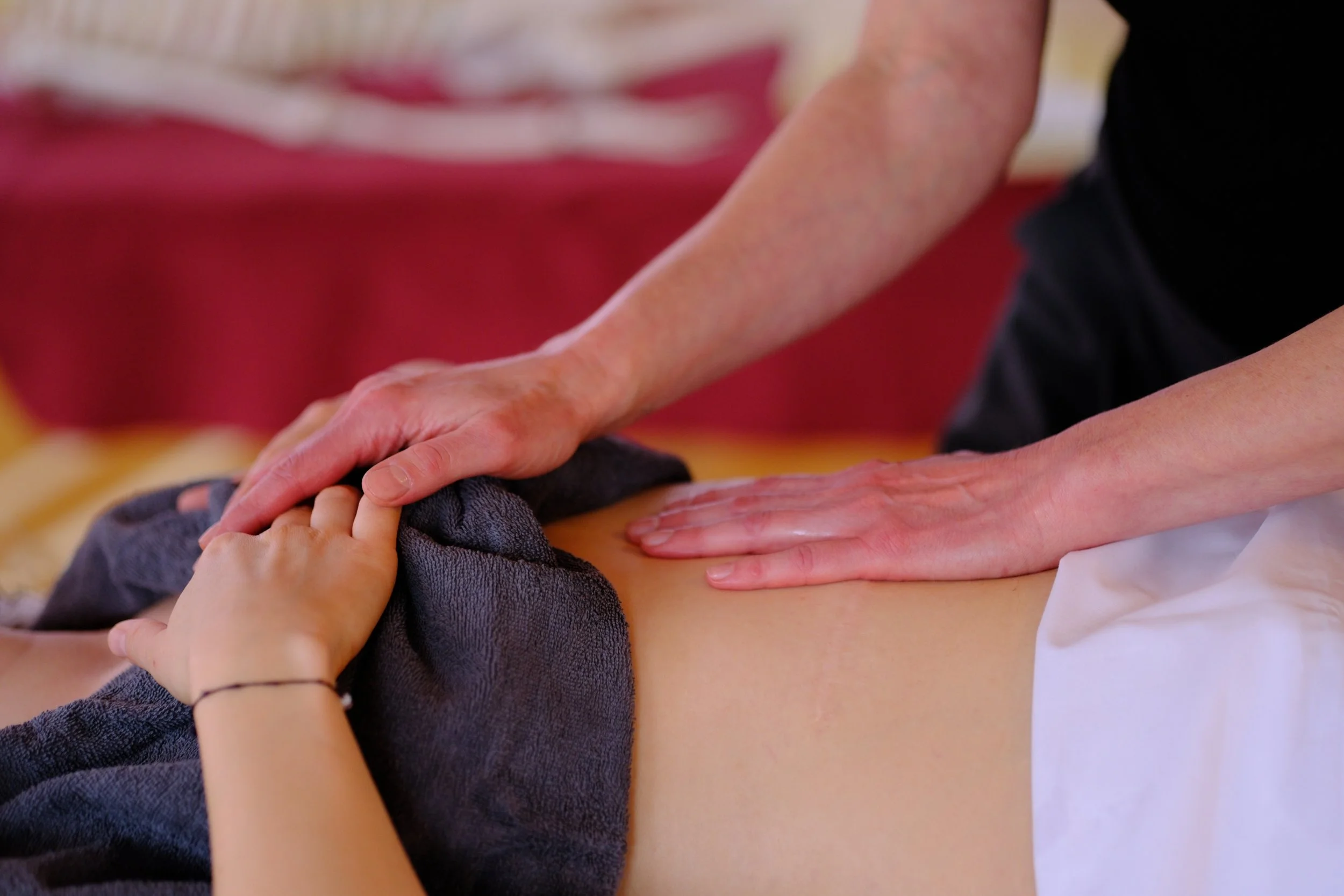 Esalen Massage Praxis – achtsame Berührung am Bauchraum zur Förderung von Selbstregulation und präsentem Raumhalten.