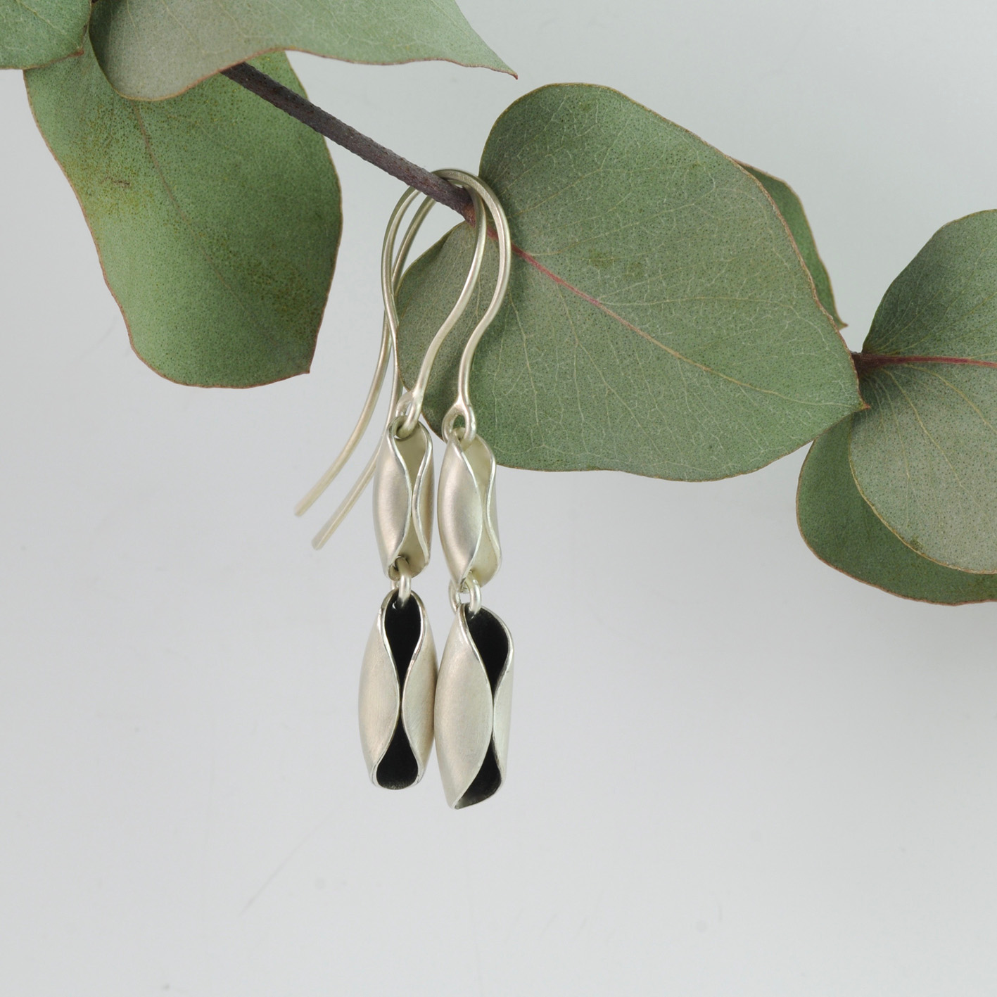 Silver and oxidised silver windblown drop earrings.jpg