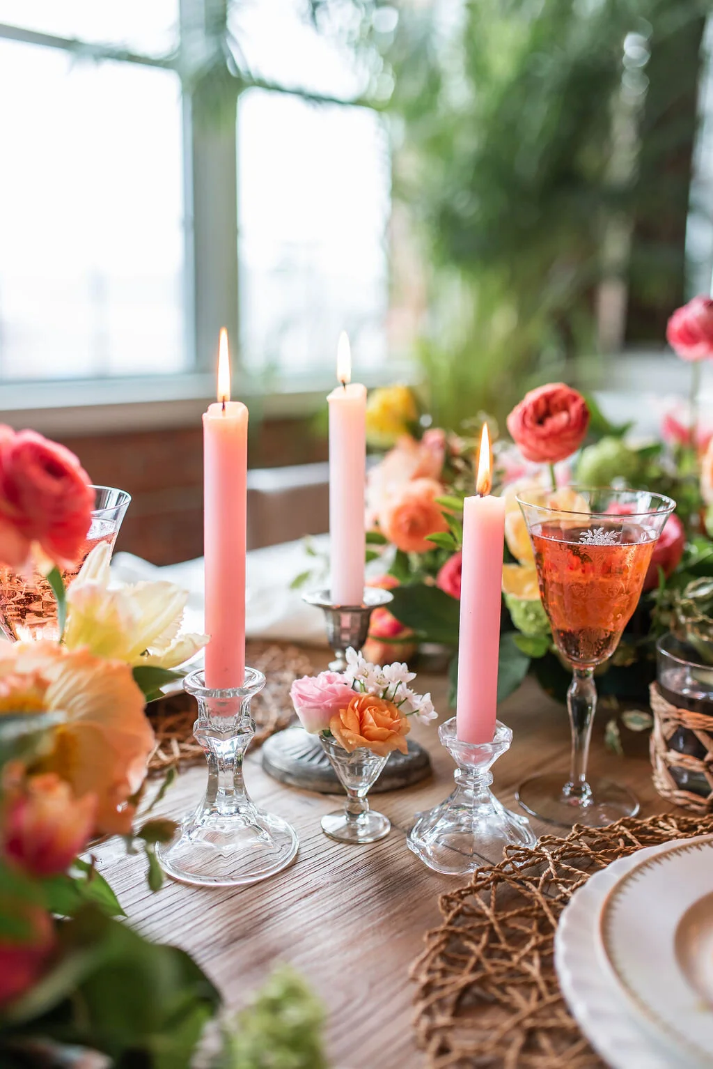 special event florals dinner party table centerpieces pink taper candles pink ranunculus flowers