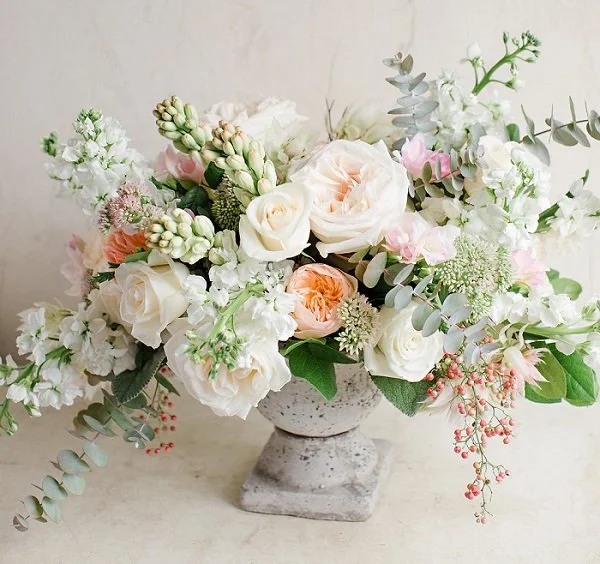 fresh floral arrangement white roses peach garden roses stone urn vase