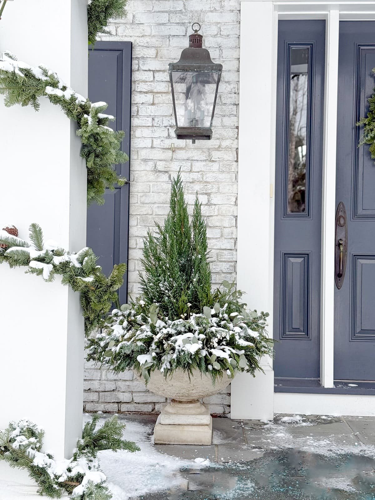 front door winter planter garland wrapped columns front entryway christmas decorations