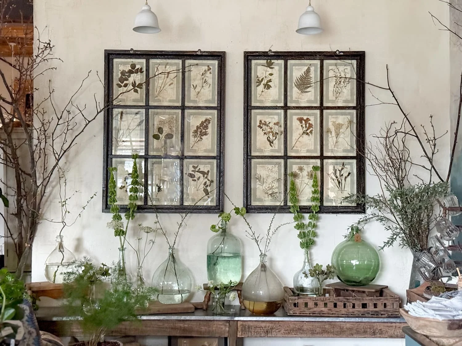 vintage glass demijohn bottles window frame dried botanicals
