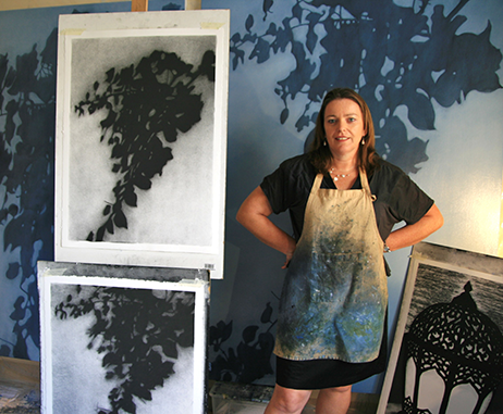 Artist Kathryn Ryan in her studio with her Dubai collection of charcoals and oil paintings