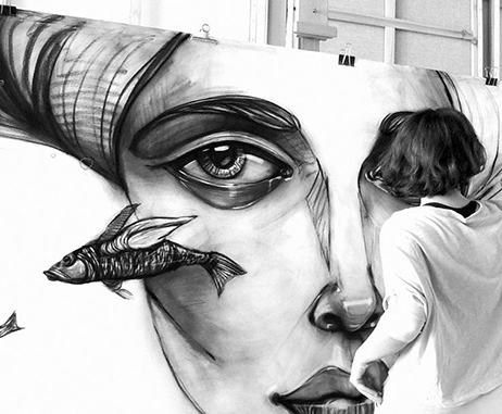Lama Khatib Daniel drawing one of her large scale charcoal drawings