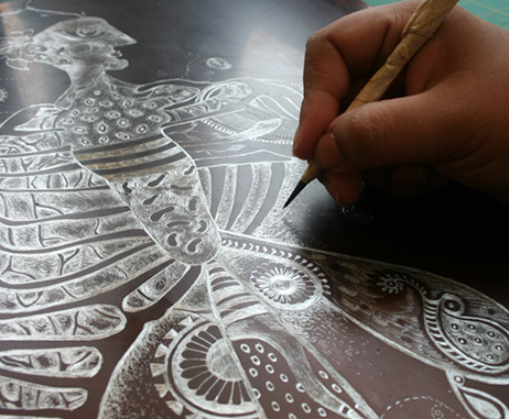 Nivedita etches her drawings ready for printmaking