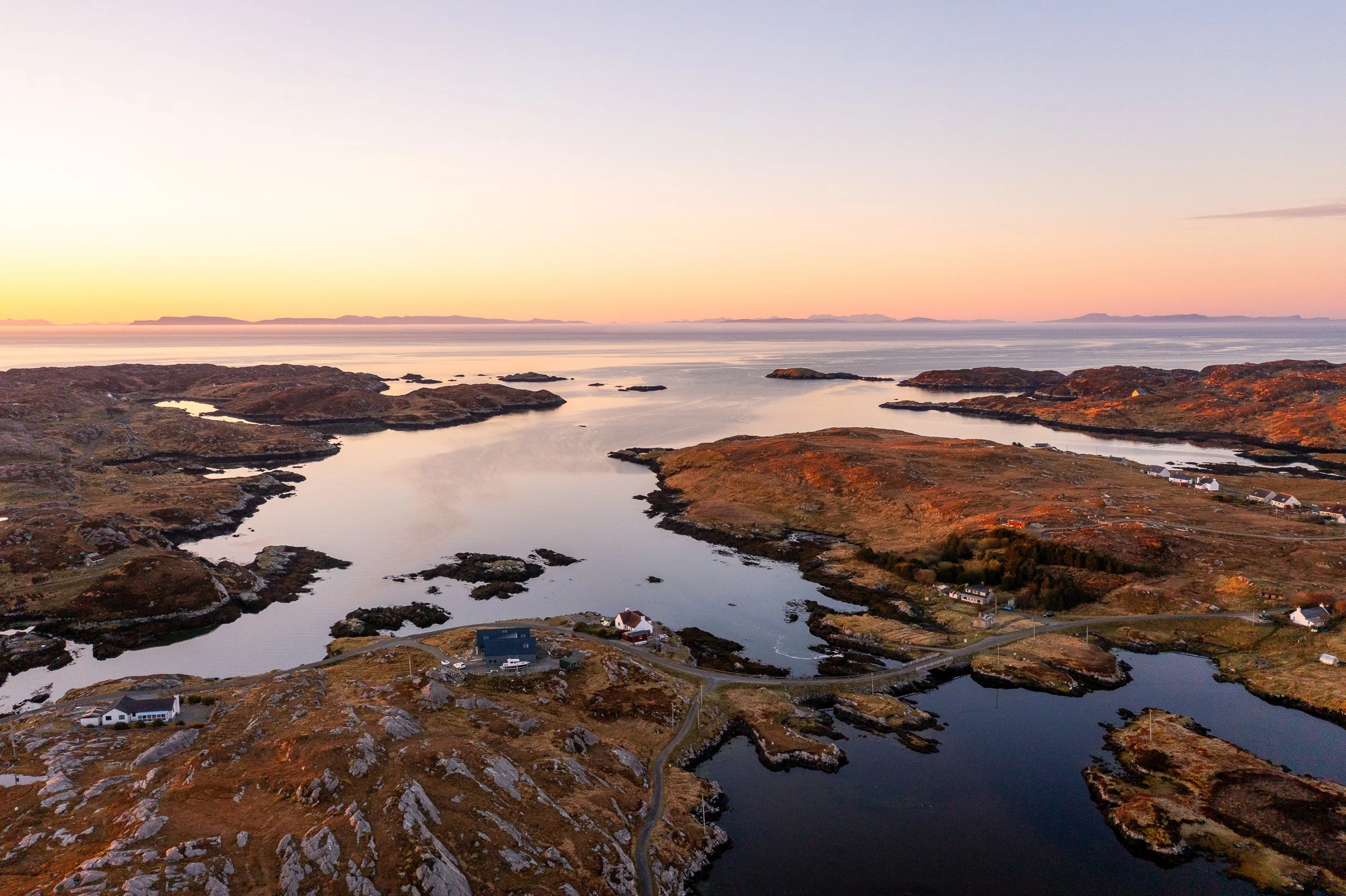 South Harris at sunset with the Isle of Skye on the horizon